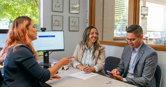 A man and woman sitting across from an estate planning attorney