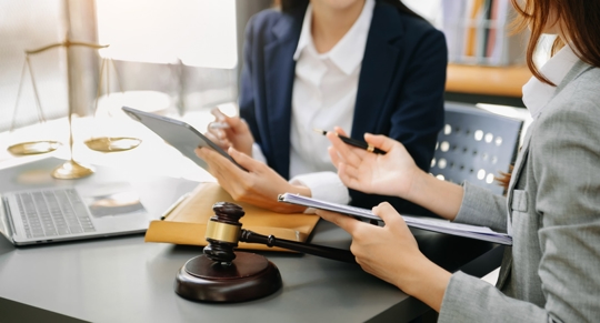 person reviewing documents with a lawyer