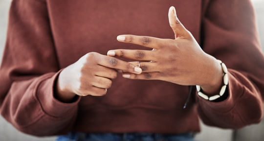 woman removing wedding ring