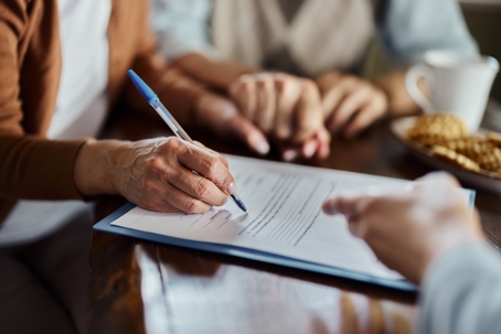 people signing documents in a law office
