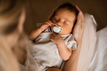 mother holding her infant on her lap