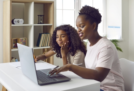 mother and daughter looking at a laptop