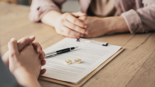 man and woman about to sign divorce papers